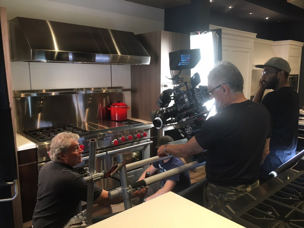 Tommy Cheatham performing grip work on a kitchen scene during a professional production shoot